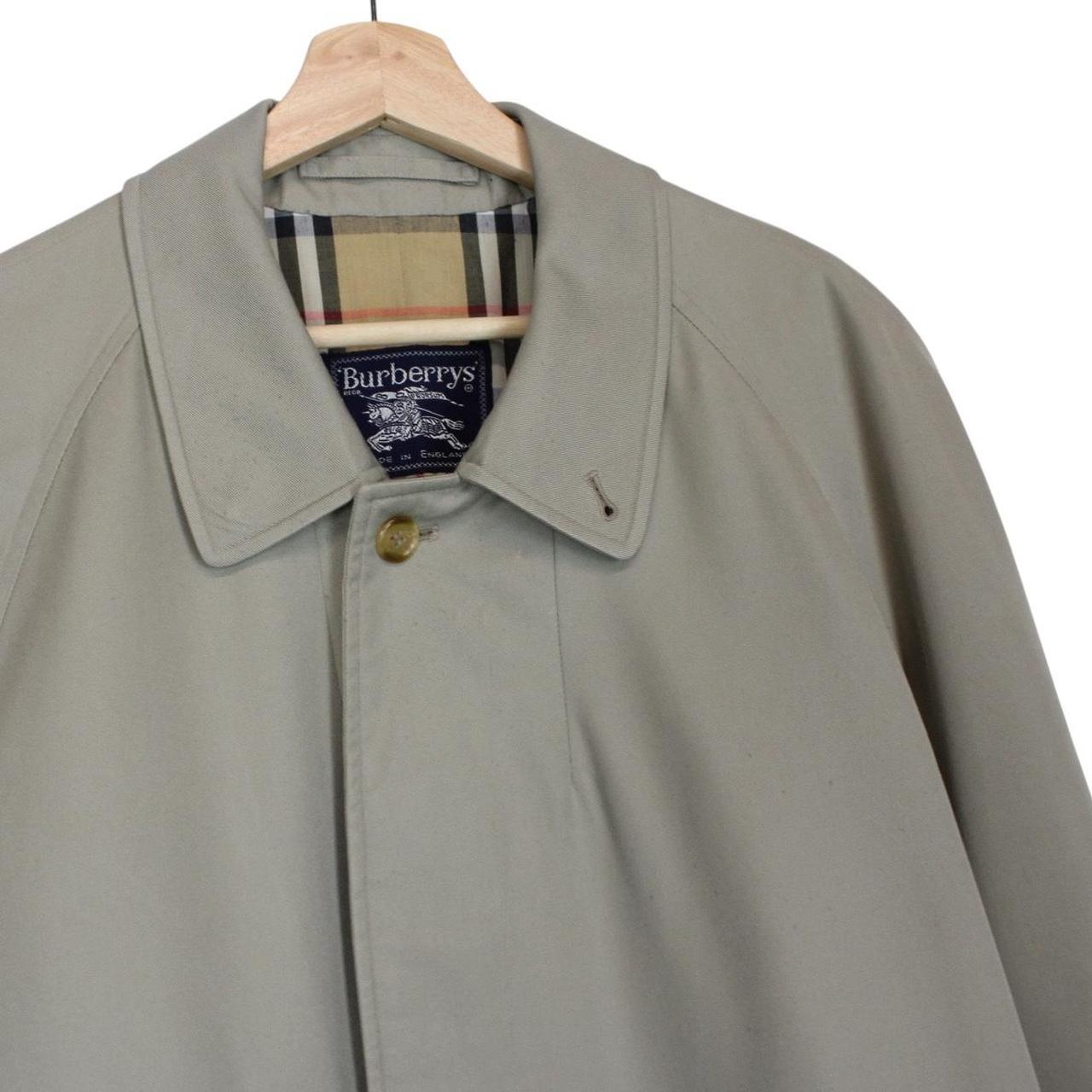 Burberry khaki green trench coat featuring Nova Check pattern and single breasted design.
