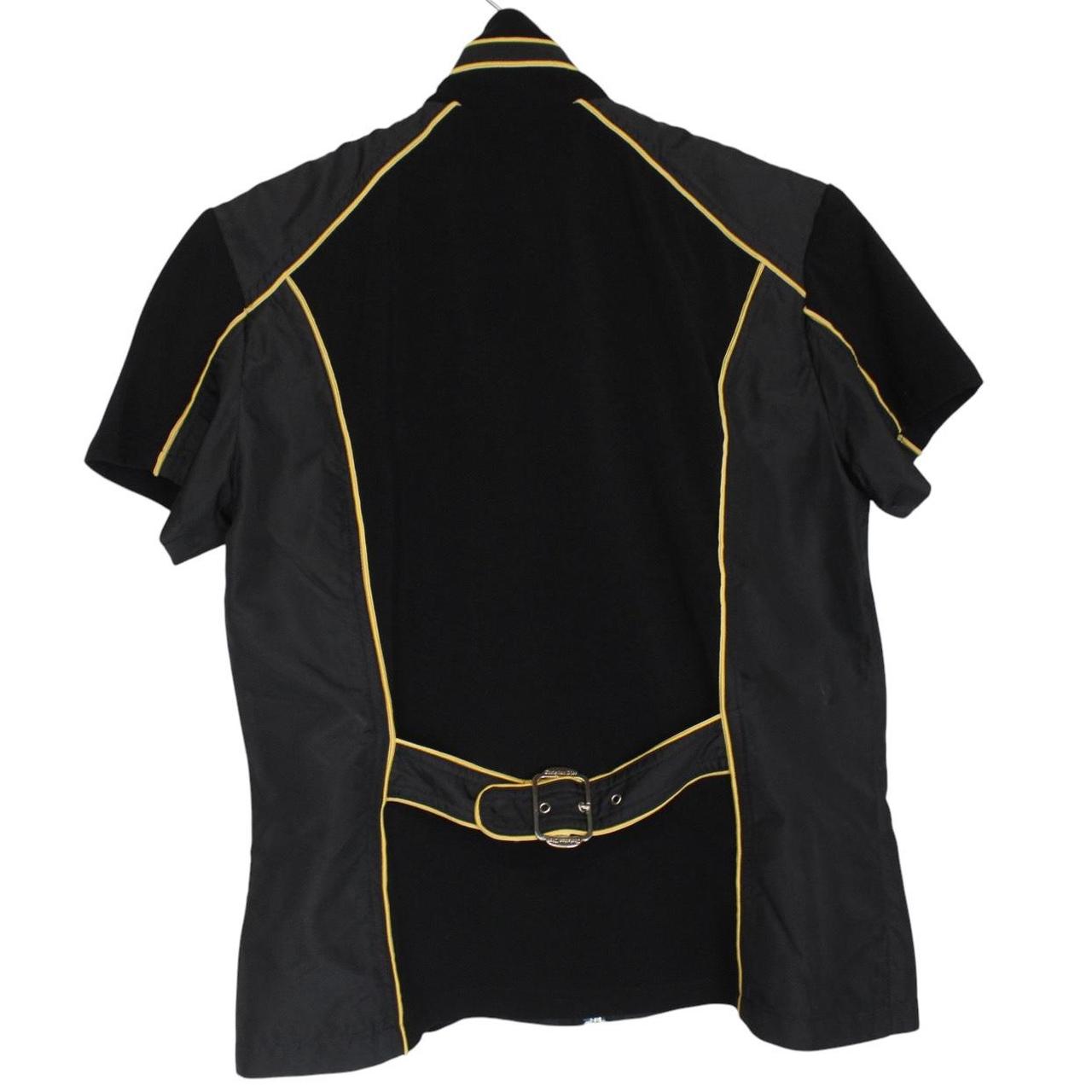 Christian Dior black and yellow jacket with 'Remove Before Flight' graphic detail.