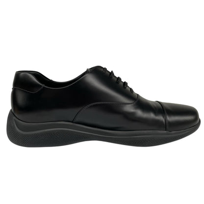 Prada black leather laced derby loafers with subtle signs of wear, includes original dust bags.