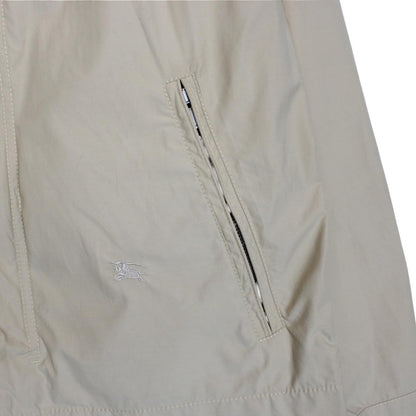 Burberry beige windbreaker jacket with full zip, logo detail, and nylon material.