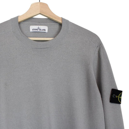 Stone Island grey wool knit jumper with logo patch and subtle wear marks.