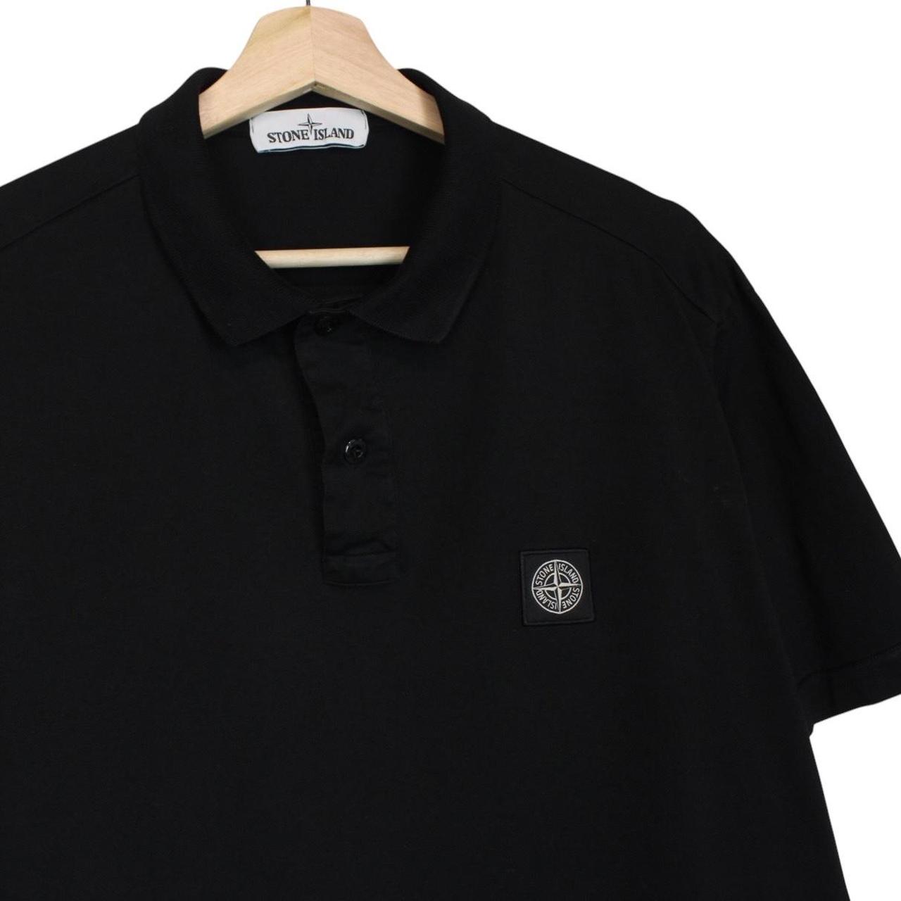 Stone Island black polo shirt with embroidered compass logo and cotton material.