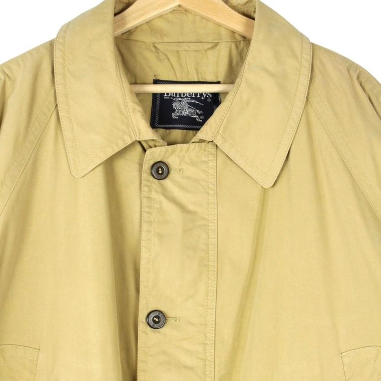 Burberry beige coat with Nova Check pattern, multi pockets, and cream lining.