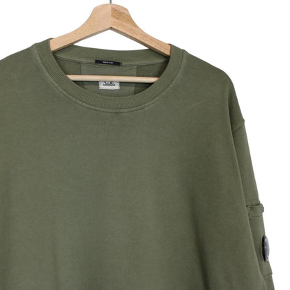 CP Company green sweatshirt diagonal fleece with signature lens detail and logo.