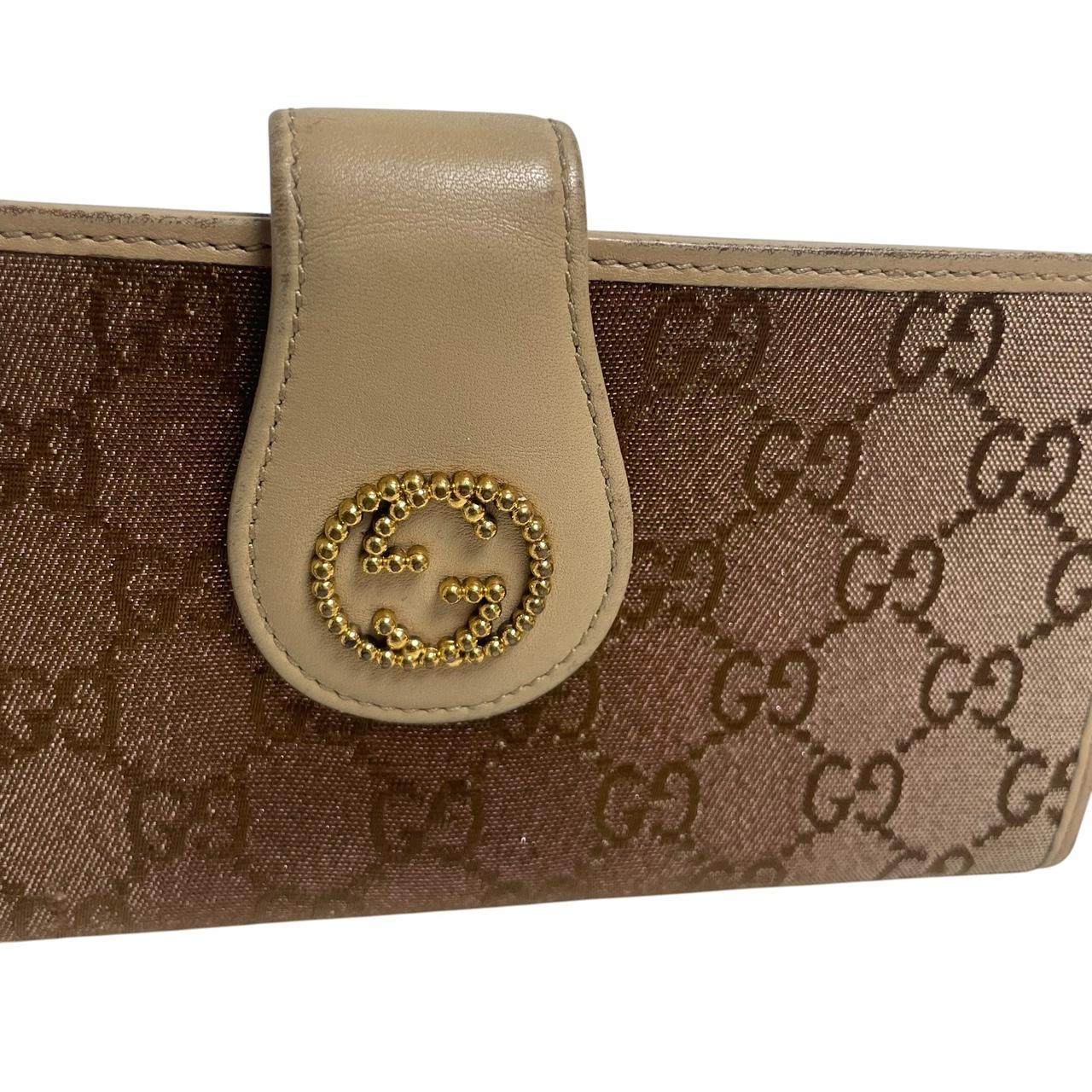 Gucci beige and pink GG monogram continental wallet with logo and wear details.