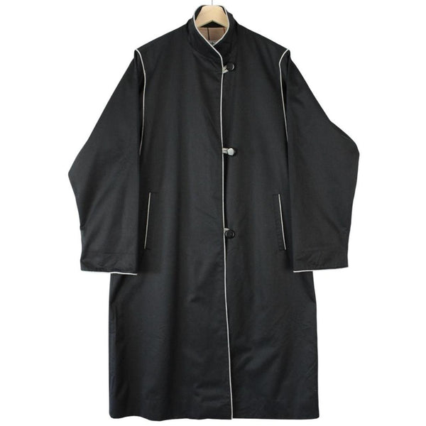 Burberry black cotton trench coat with single breasted design and classic logo detailing.