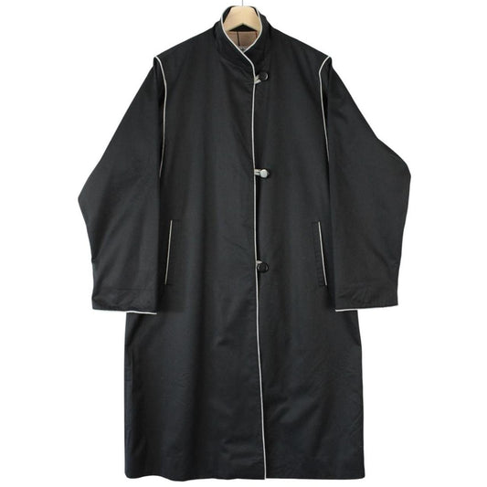 Burberry black cotton trench coat with single breasted design and classic logo detailing.