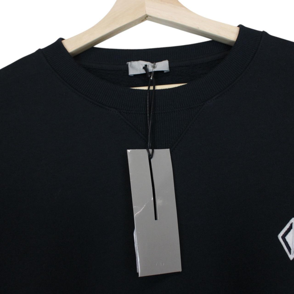 Dior navy blue sweatshirt featuring embroidered CD icon logo on cotton material.