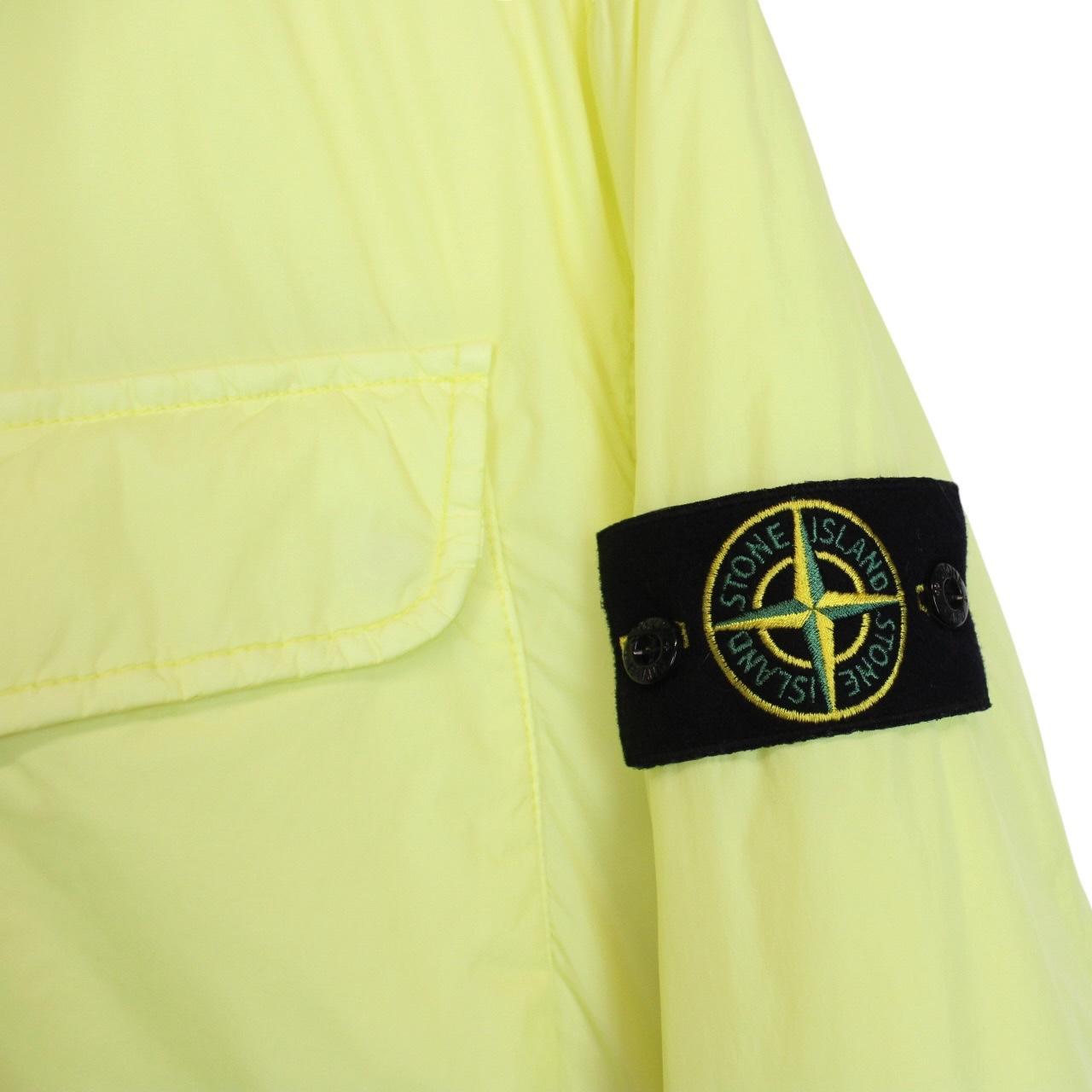 Stone Island yellow jacket with crinkle texture and logo badge on sleeve.