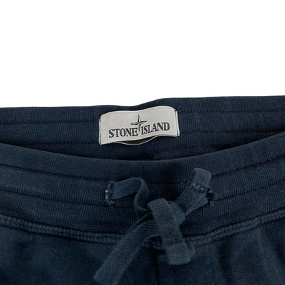 Stone Island navy blue joggers with logo patch and cotton material.