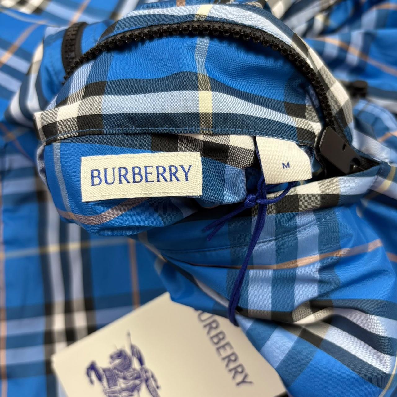 Burberry reversible windbreaker jacket in blue and black with Nova Check pattern.
