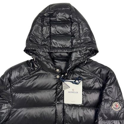 Moncler black hooded puffer jacket with logo patch and nylon material.