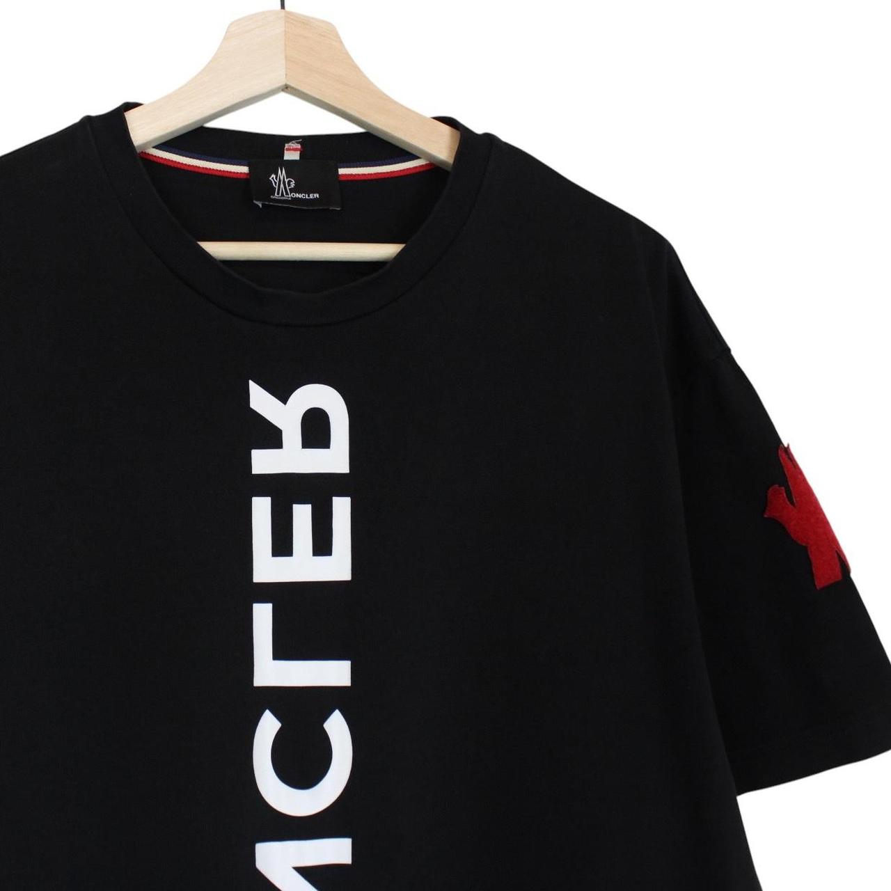 Moncler black and white short sleeve t-shirt with vertical logo design.