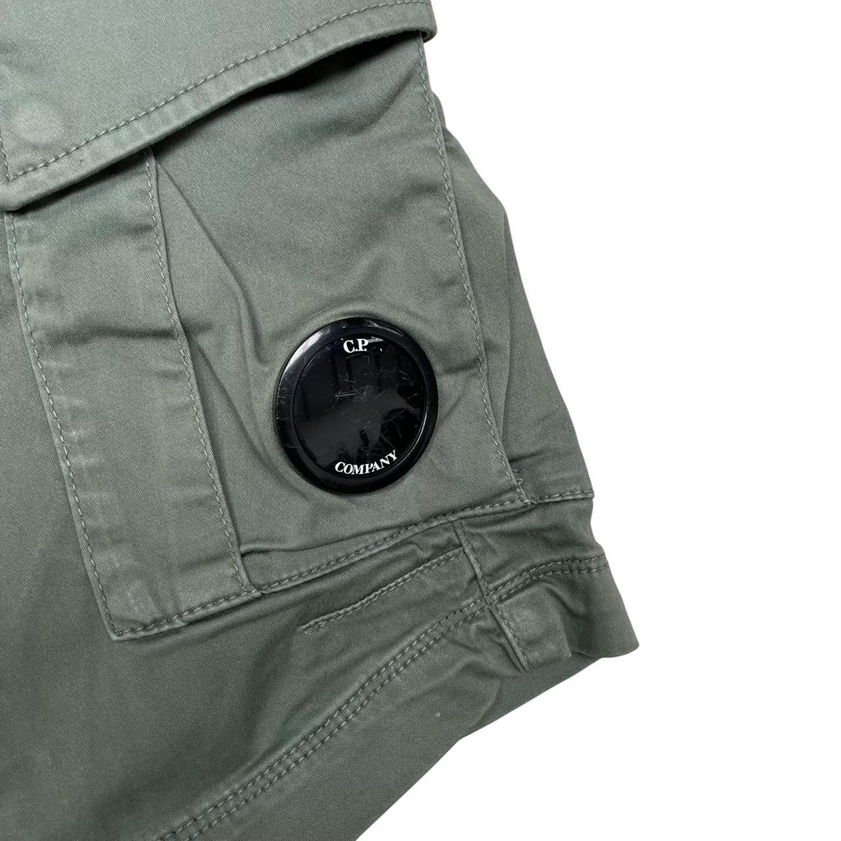 CP Company green cargo shorts with lens detail and cotton material, size XL.