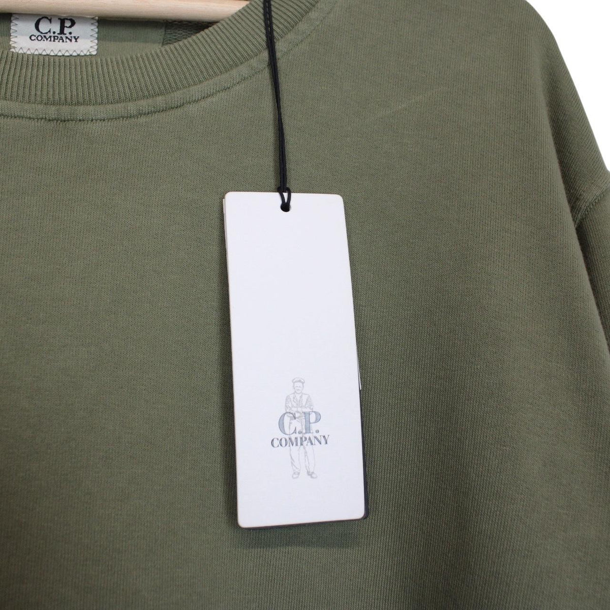 CP Company green sweatshirt diagonal fleece with signature lens detail and logo.
