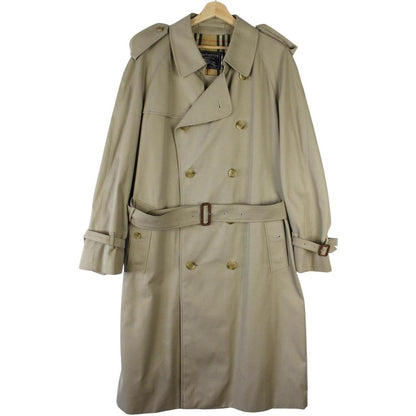 Burberry beige double-breasted belted trench coat with classic check lining and logo detail.