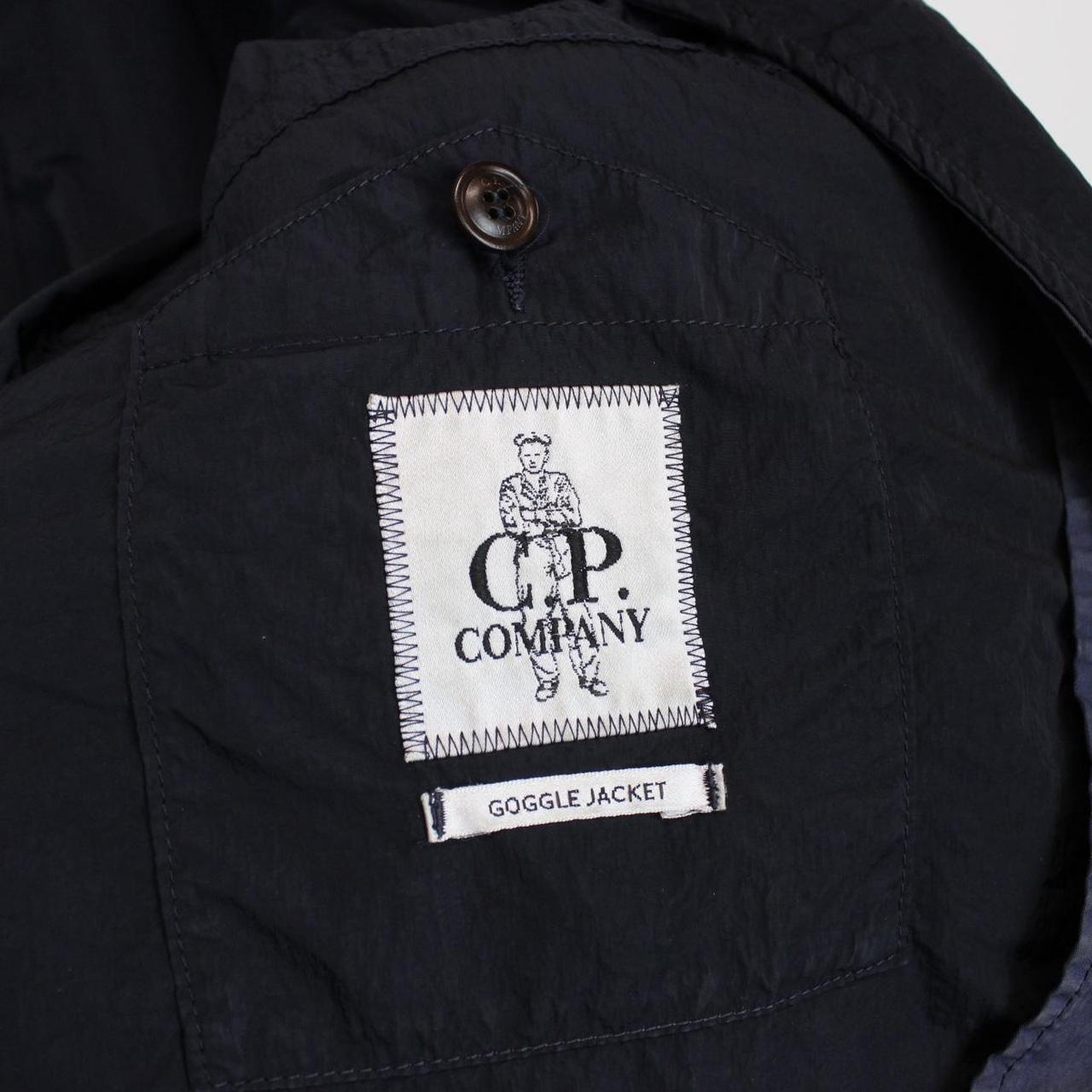 CP Company navy blue nylon jacket with multi pockets and garment dyed finish.