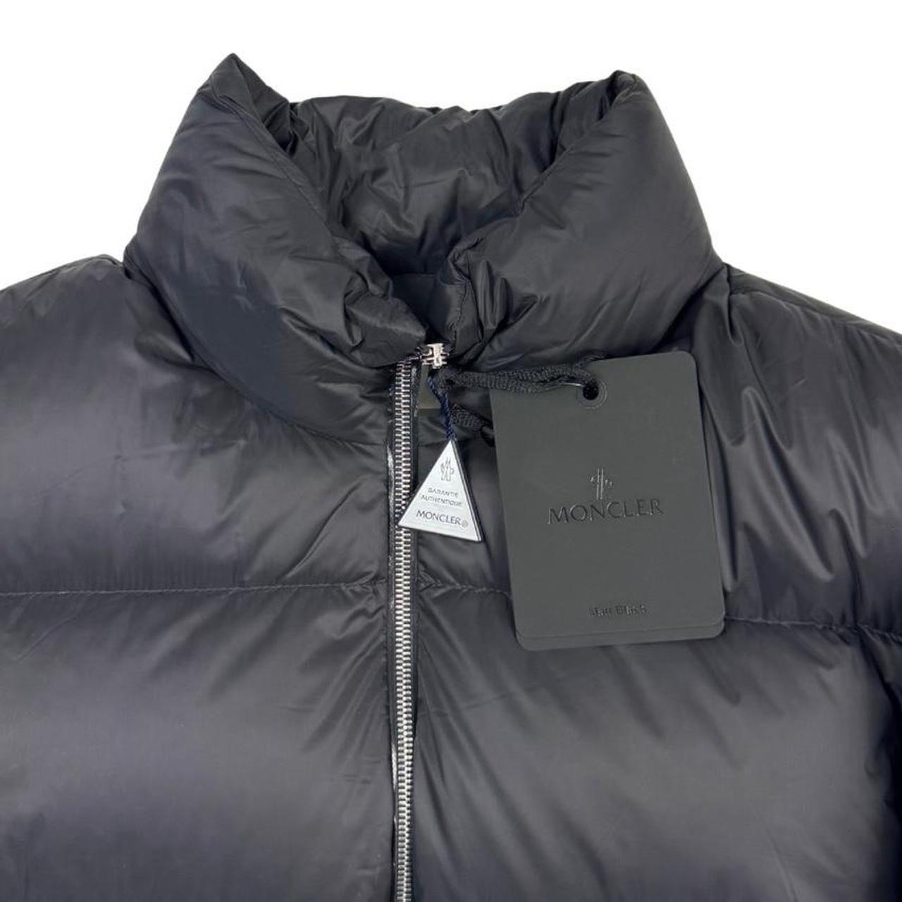 Moncler black nylon down puffer jacket with logo patch and quilted design.