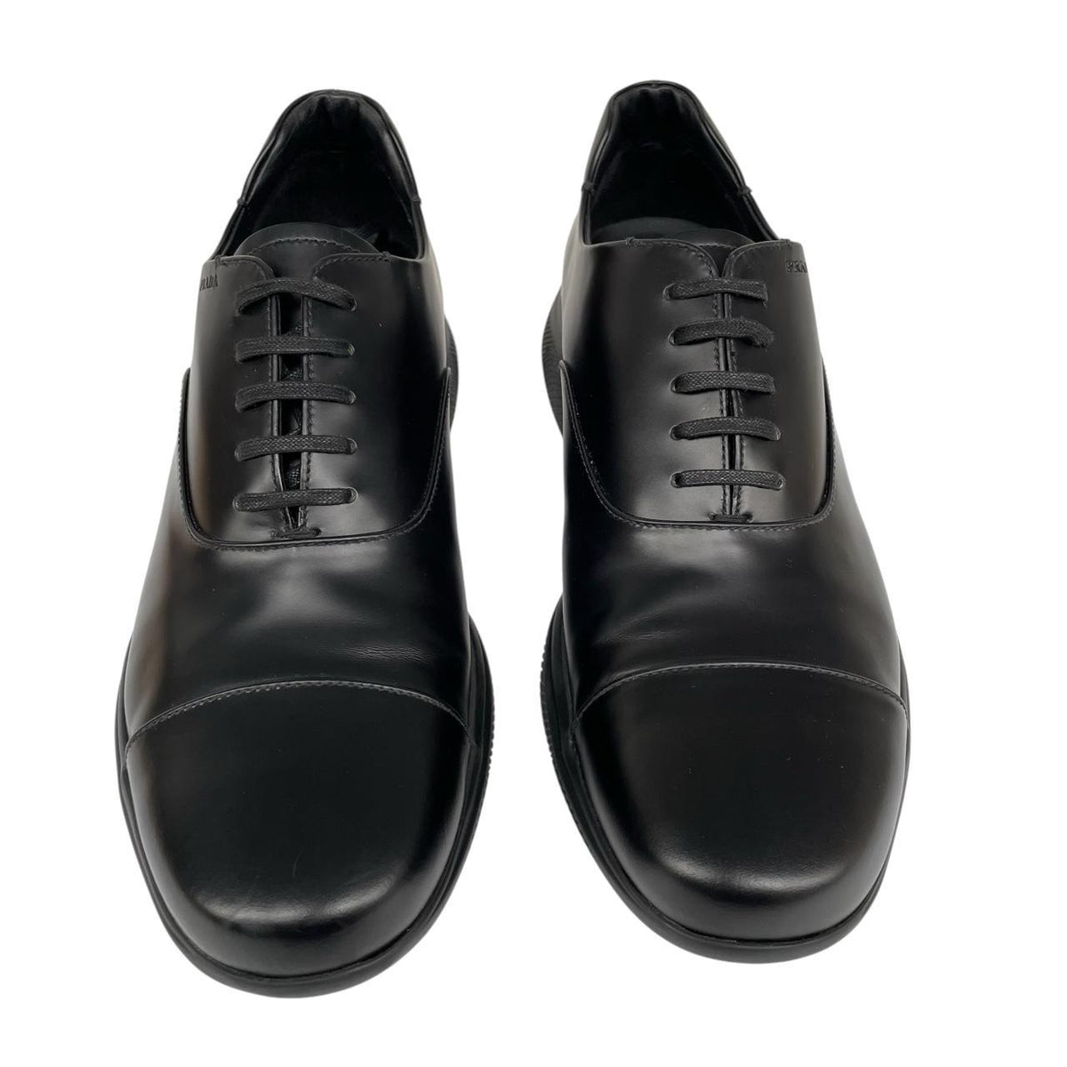 Prada black leather laced derby loafers with subtle signs of wear, includes original dust bags.