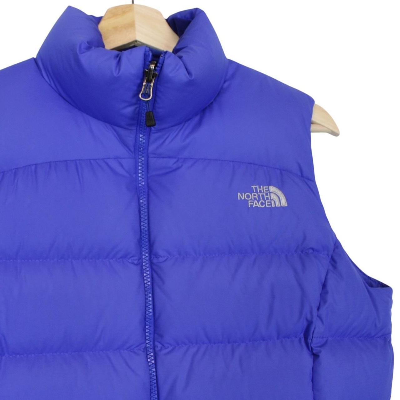 The North Face blue down gilet with logo detail and quilted pattern.