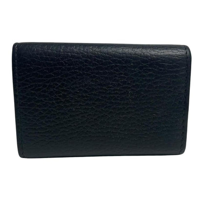 Gucci black leather key case with GG logo and quilted pattern.