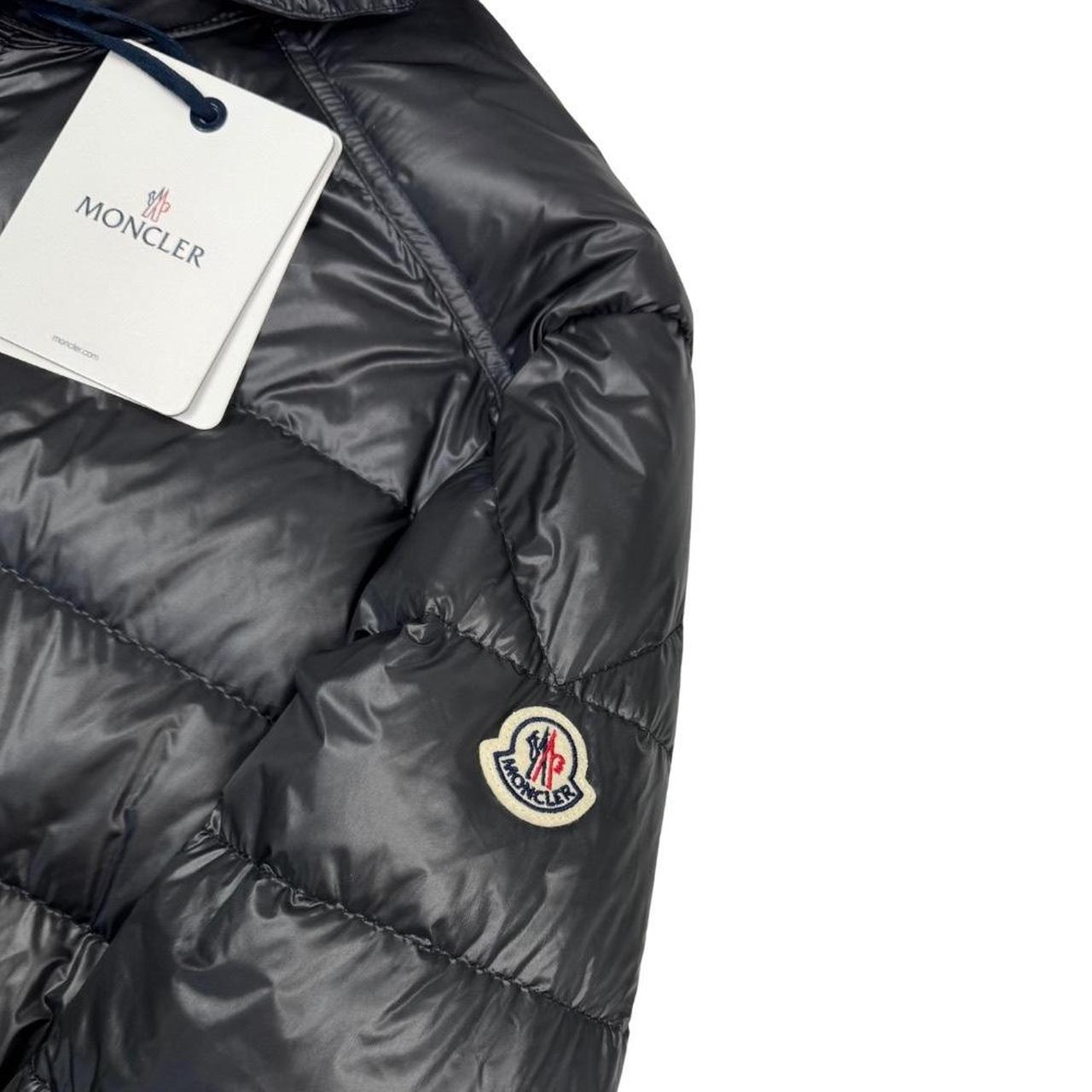 Moncler grey down nylon hooded puffer jacket with logo patch and quilted design.