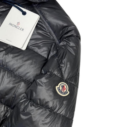 Moncler grey down nylon hooded puffer jacket with logo patch and quilted design.