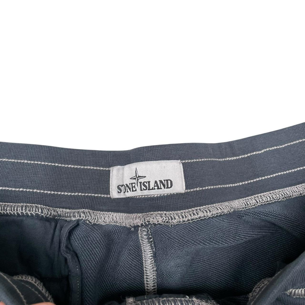 Stone Island khaki brown jogger shorts cotton material with logo patch on pocket.