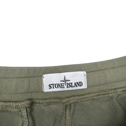 Stone Island green jogger shorts with logo patch and cotton material.