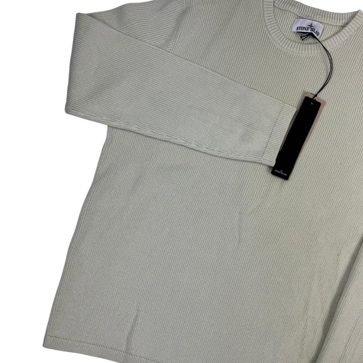 Stone Island beige waffle knit jumper with logo patch and organic cotton material.