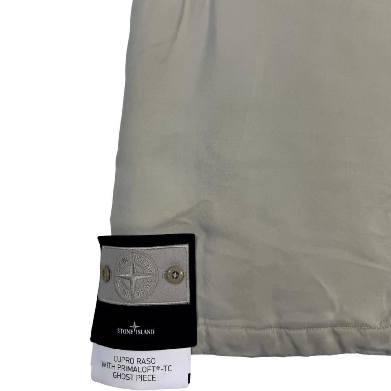 Stone Island beige vest jacket with logo patch and Primaloft material.