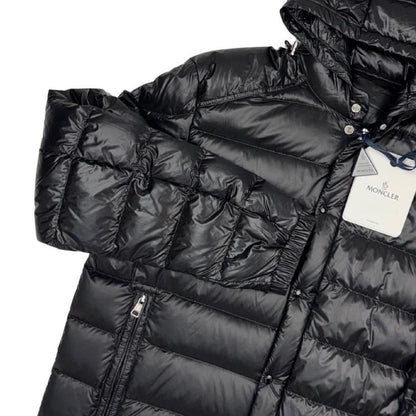 Moncler black hooded puffer jacket with logo patch and nylon material.