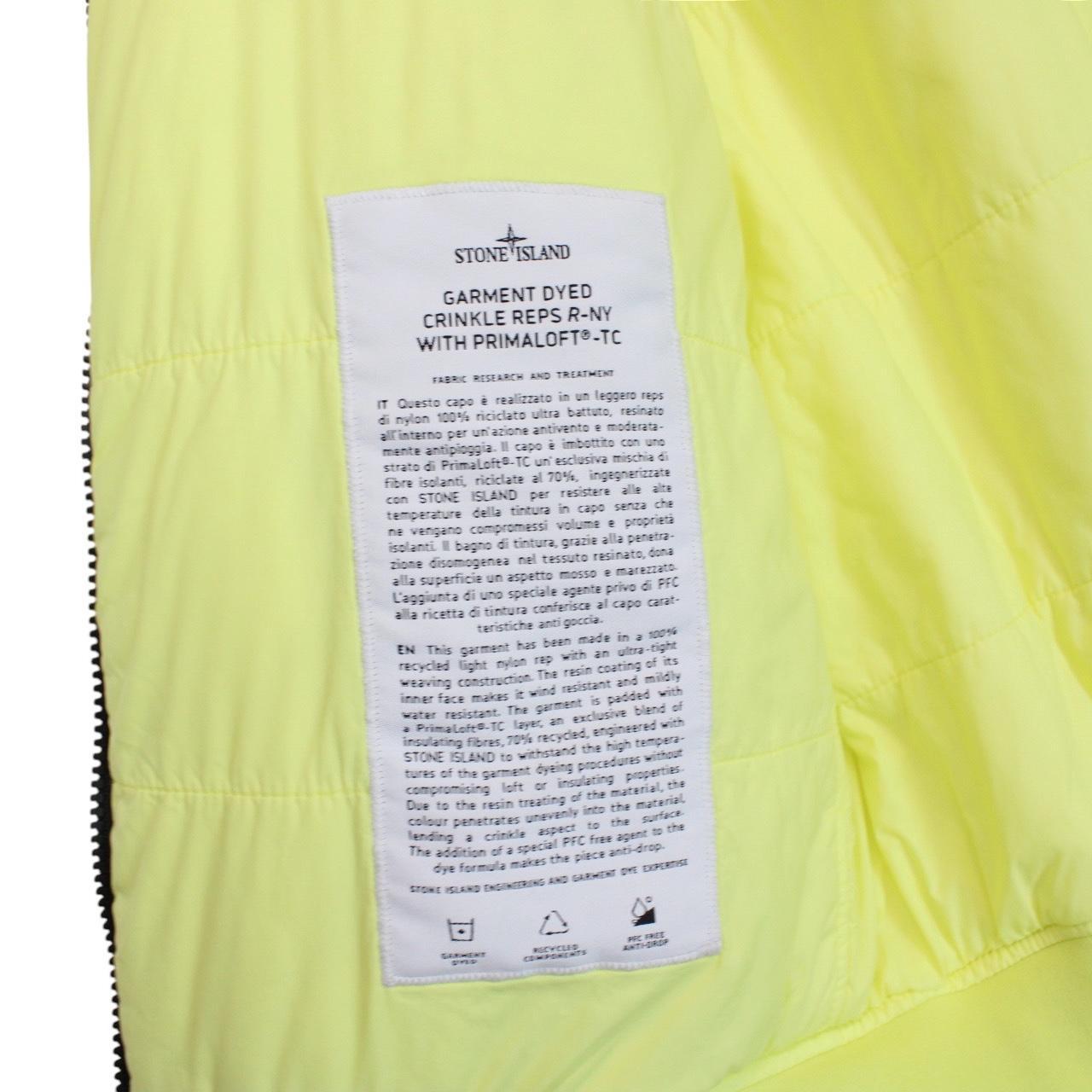 Stone Island yellow jacket with crinkle texture and logo badge on sleeve.