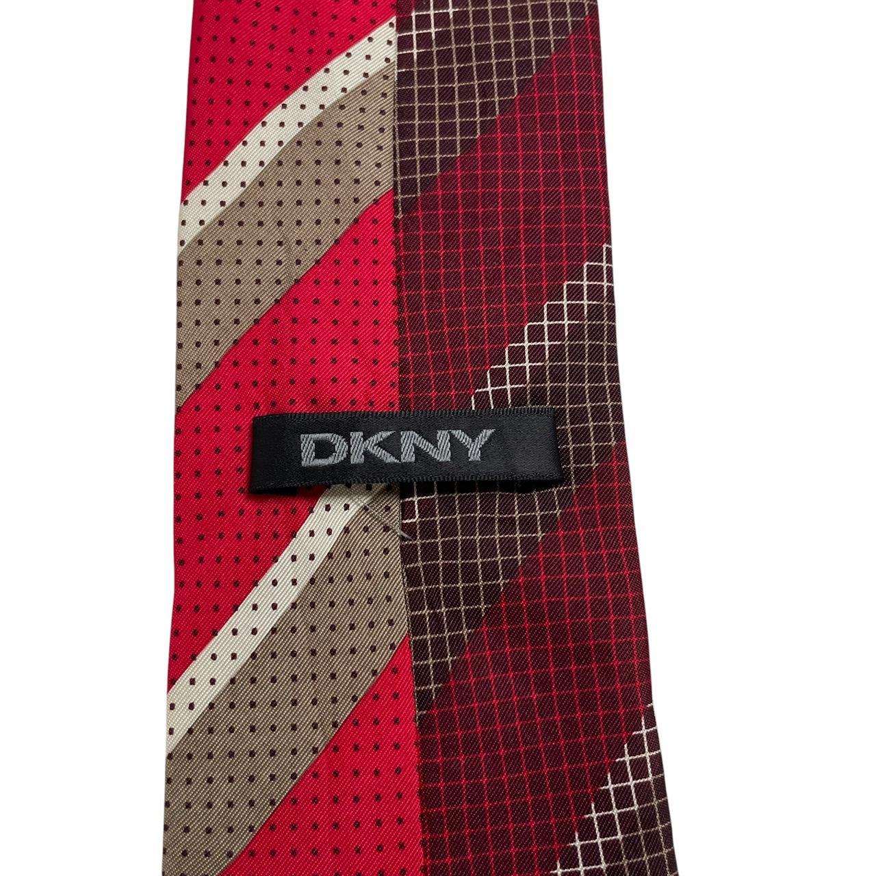 DKNY red silk tie with vintage stripes and logo detail.