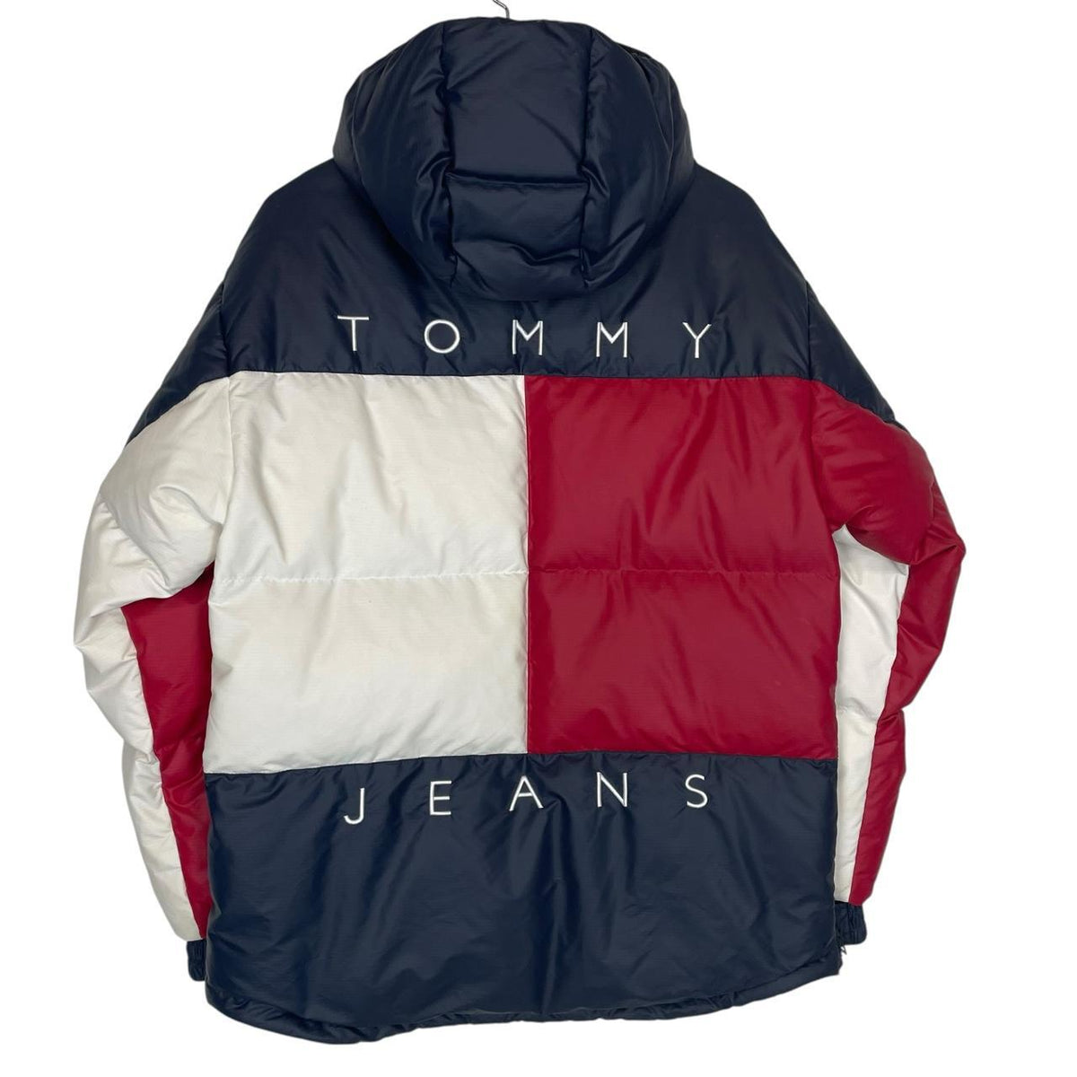 Tommy Hilfiger navy blue pullover jacket with 1/4 zip and hood, nylon material.