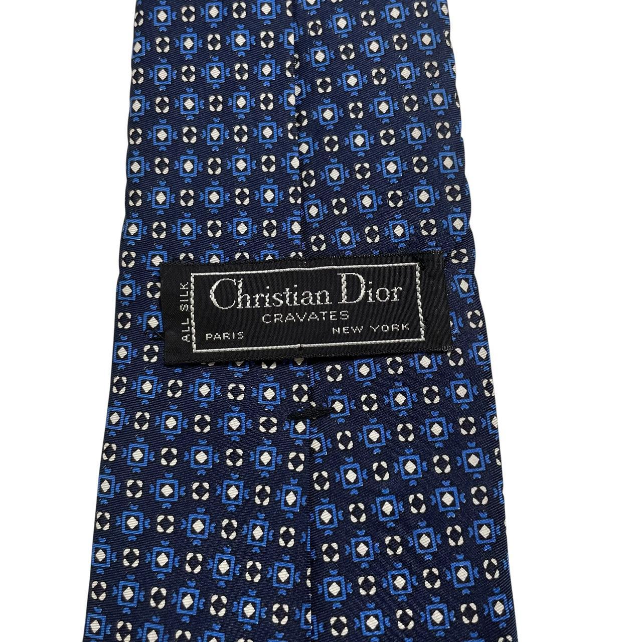 Christian Dior navy blue silk tie with subtle sheen and classic design.