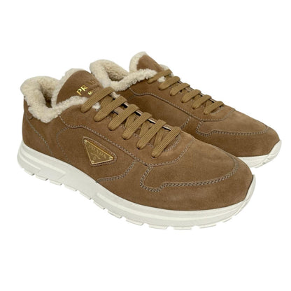 Prada brown suede trainers with shearling lining and logo detail.