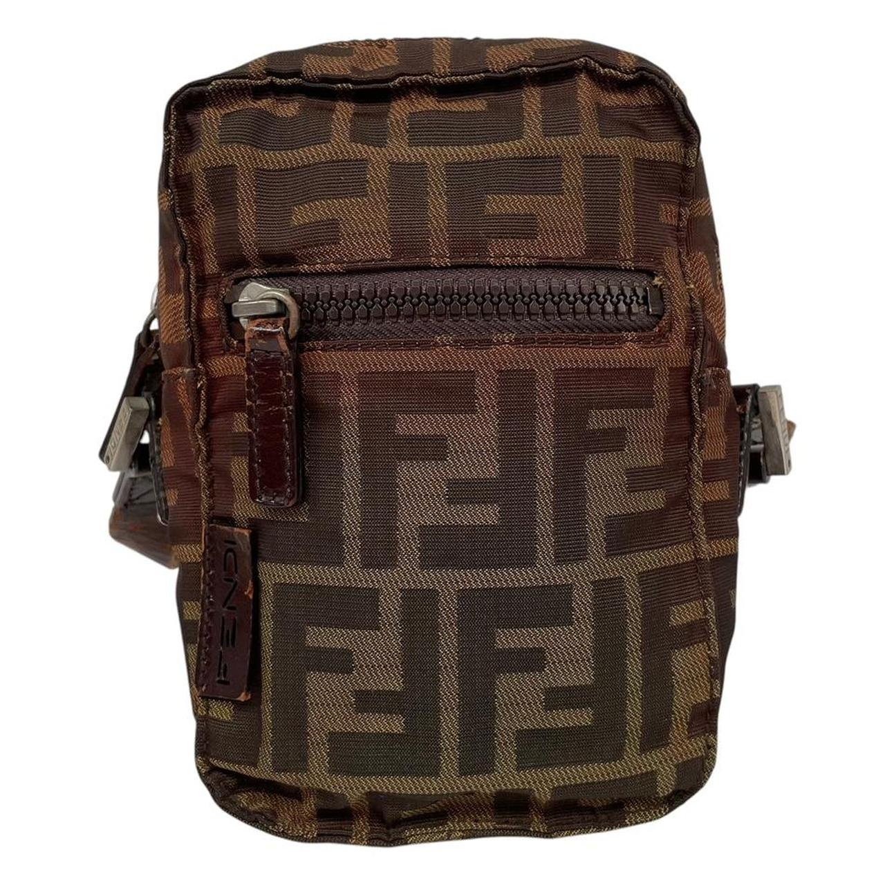 Fendi brown duffel bag with monogram canvas, visible wear and cracking on strap.
