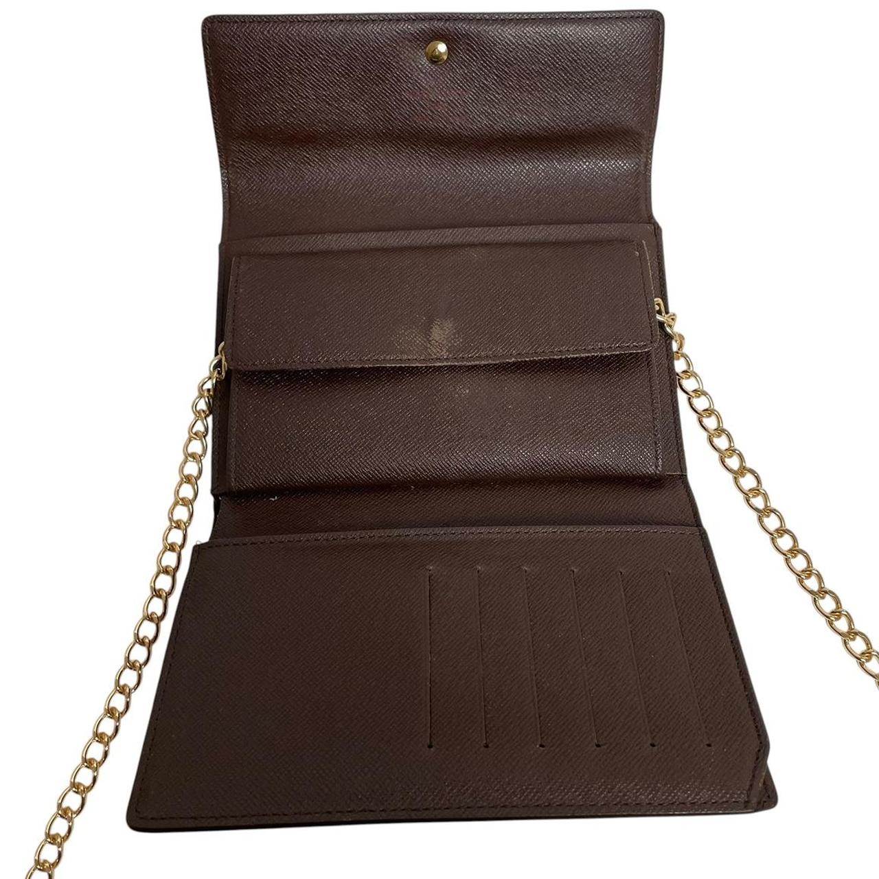 Louis Vuitton gold crossbody wallet Damier Ebene canvas with removable strap and logo.
