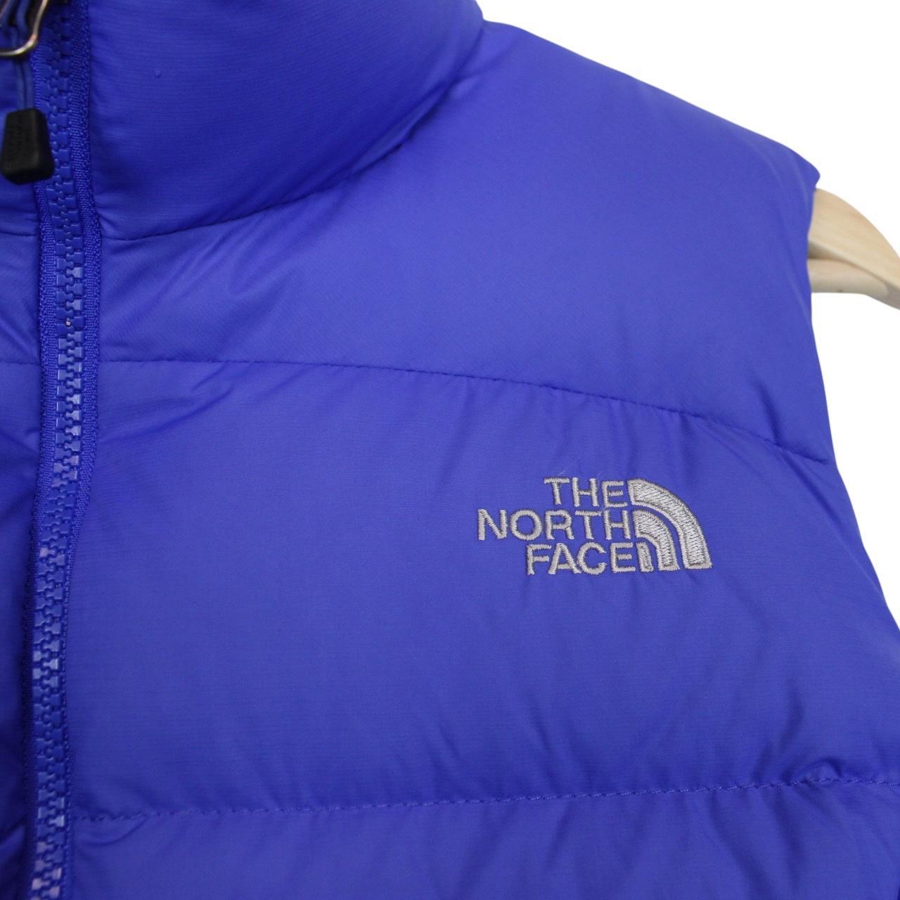 The North Face blue down gilet with logo detail and quilted pattern.