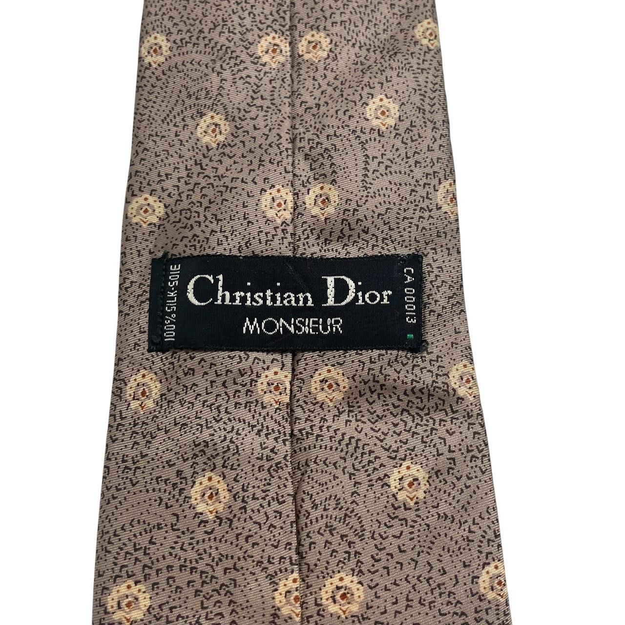Christian Dior brown silk tie with subtle sheen and classic design elements.
