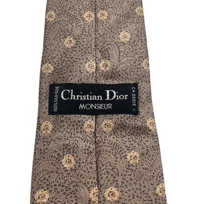 Christian Dior brown silk tie with subtle sheen and classic design elements.