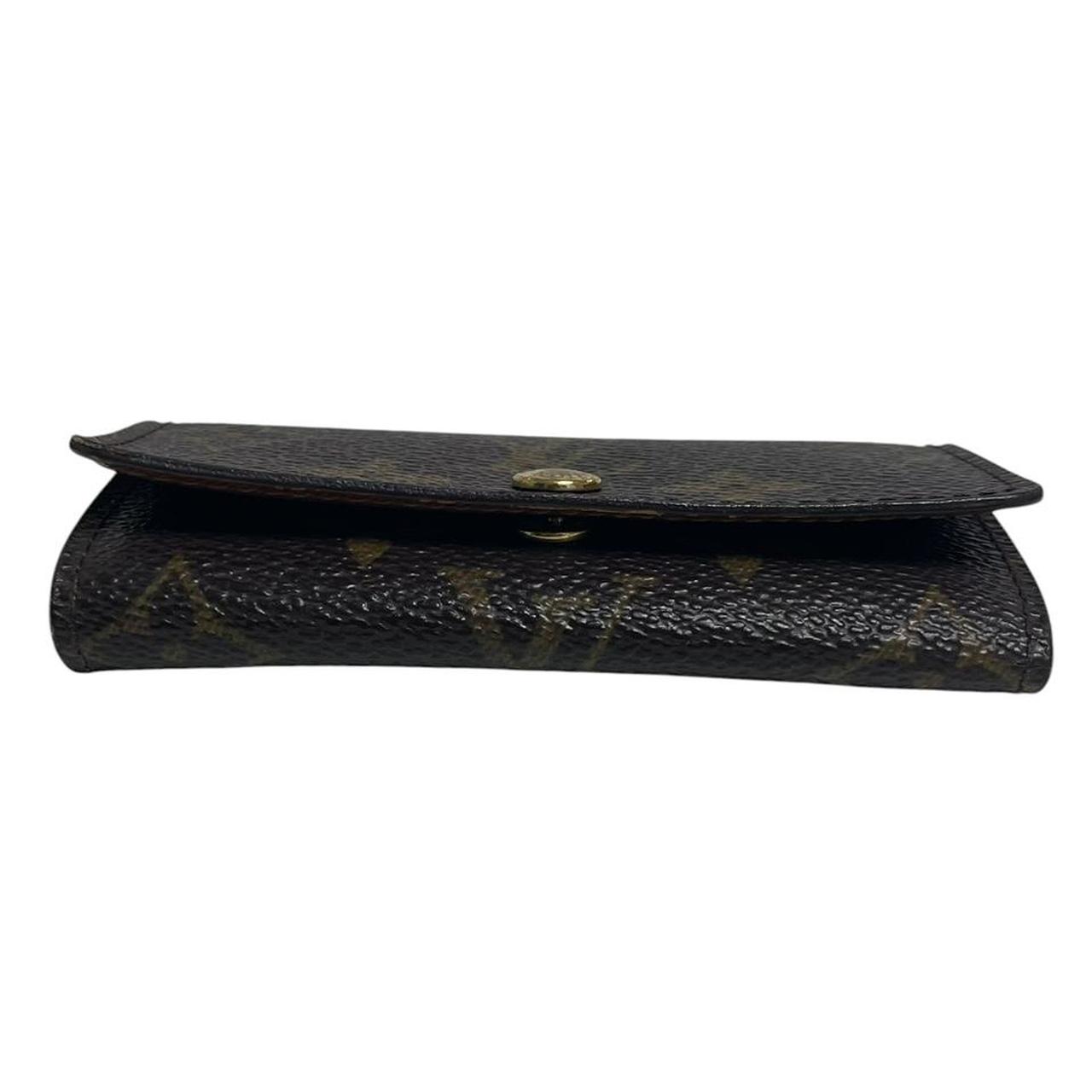 Louis Vuitton brown and tan monogram canvas key case with logo detail.