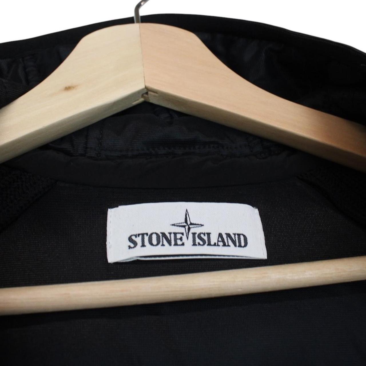 Stone Island black jacket with special process badge and full zip design.