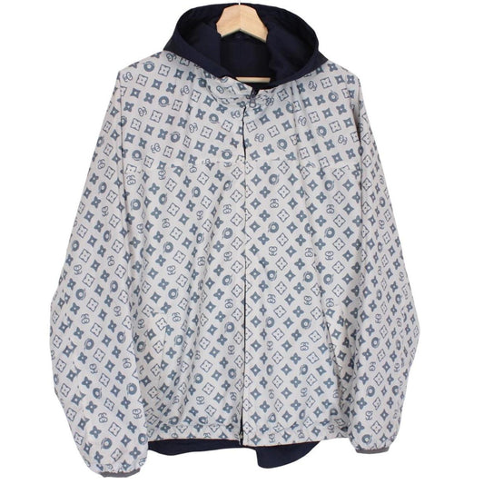 Stüssy reversible nylon jacket in grey and navy blue with logo detailing.