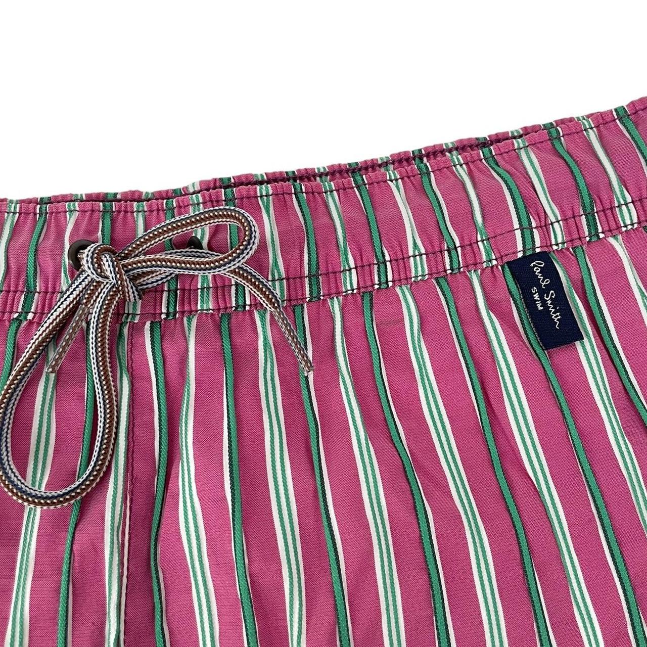 Paul Smith red swim shorts with striped pattern and cotton material.