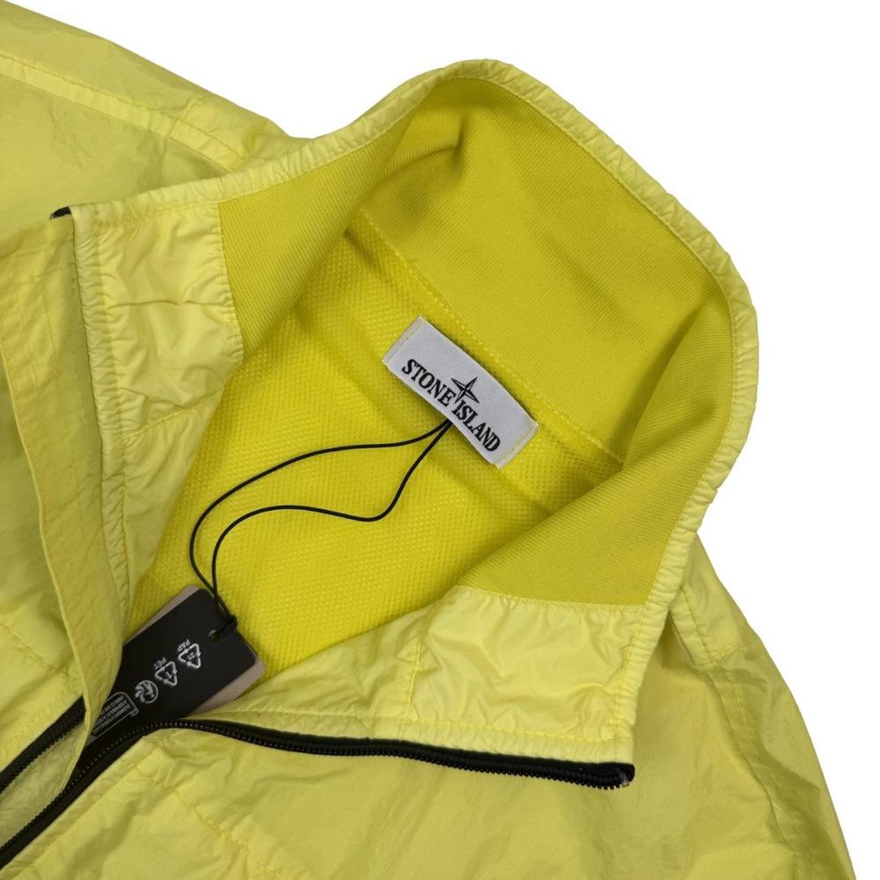 Stone Island yellow full zip jacket with crinkle texture and iconic compass logo.