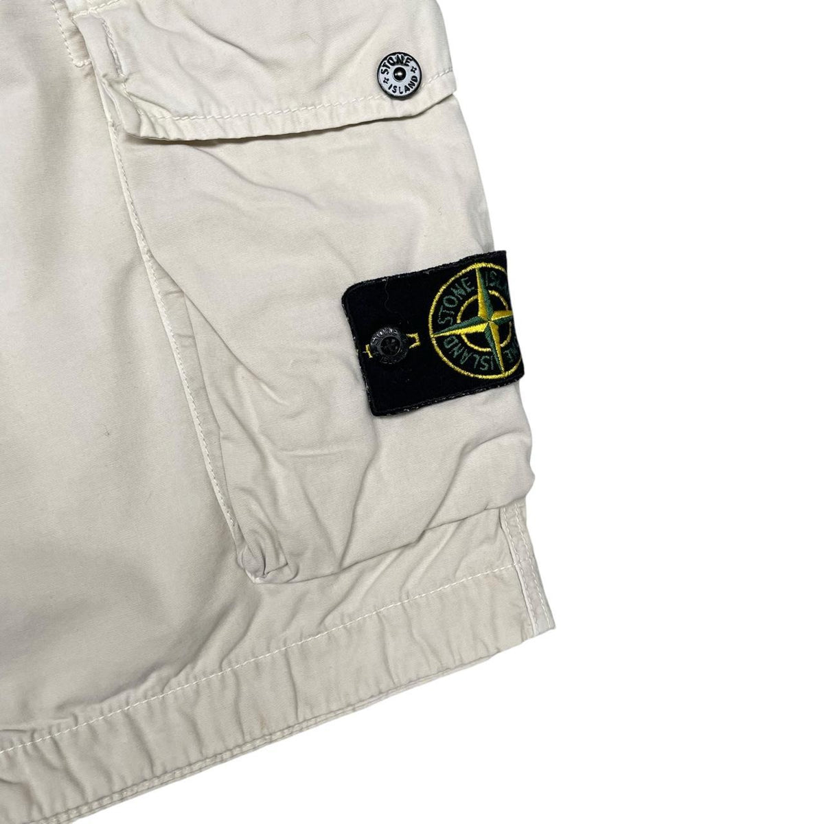 Stone Island beige cargo shorts with logo patch and cotton material.