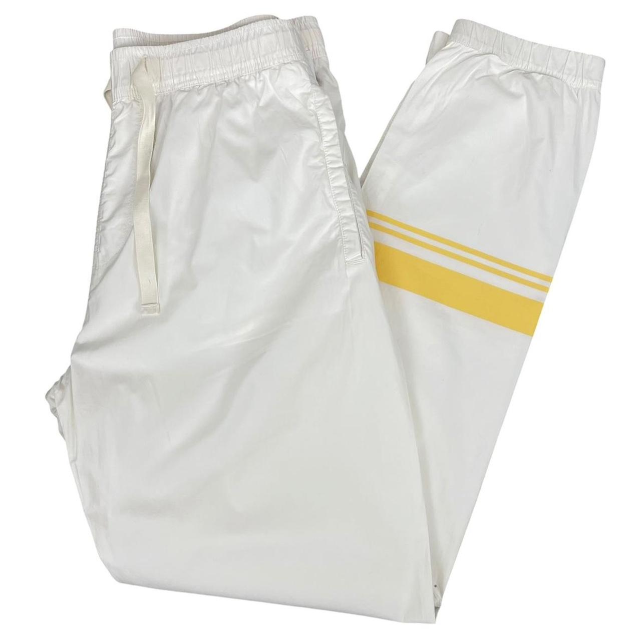 Stone Island white and yellow trousers with logo patch and RE-T fit design.