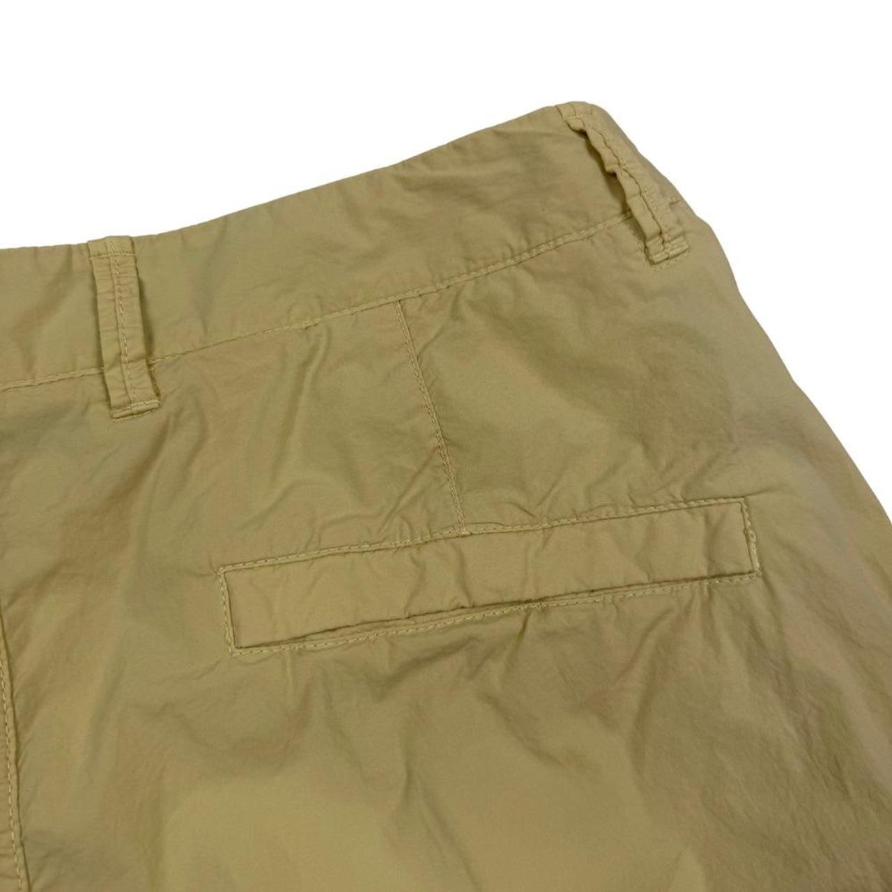 Stone Island beige cargo shorts with logo patch and multiple pockets in cotton material.